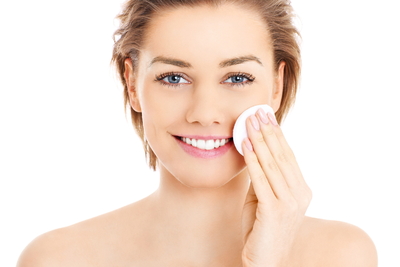 happy-woman-cleaning-her-face-with-cotton-pads-over-white-background